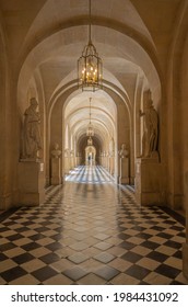 Versailles, France - 19 05 2021: Castle of Versailles. Stone corridor, staircase and statues inside the Castle of Versailles