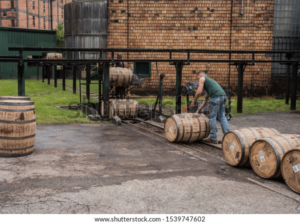 Versailles, United States: May\
5th, 2016: Worker Sealing Barrels as they Roll outside bourbon\
distillery
