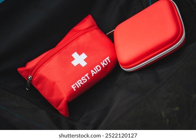 A versatile first aid kit essential for outdoor activities, featuring a red pouch and compact case for easy access to medical supplies