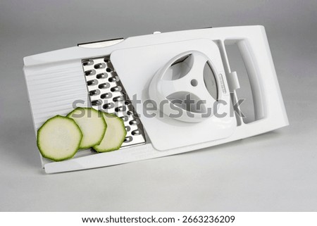 A versatile kitchen slicer designed for precise food preparation, perfect for slicing vegetables and creating healthy meals.