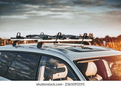 Versatile Roof Rack for Station Wagons: Safely Transporting Sports Equipment and Big Items. A roof rack or bar on a station wagon or estate car. Transportation of sports equipment in the family car.