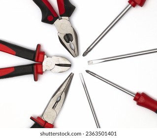 A versatile set of tools (top-down view): screwdrivers for screw manipulation and pliers, indispensable for gripping, bending, and cutting materials, making them essential for tasks in DIY projects.