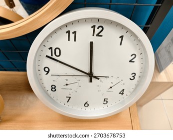 A versatile wall clock featuring integrated temperature and humidity gauges, perfect for monitoring environmental conditions alongside time in any modern space.