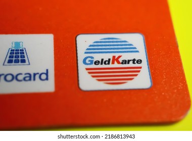 Versen, Germany - July 9. 2022: Closeup Of Orange Color German Girocard And Geldkarte (focus On Center Of Red Letter K)