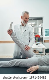 Vertebrologist Performing A Straight Leg Raise Test