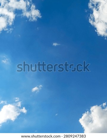 Vertical 4:5 composition of blue sky with soft white clouds and spacious copy space. Ideal natural background for posters, Pinterest and mobile design.