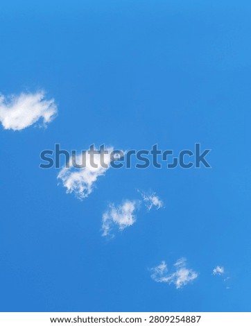 Vertical 4:5 composition of blue sky with small white clouds and spacious copy space. Minimal natural background ideal for posters, Pinterest and mobile graphics.