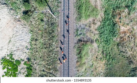 Vertical aerial top down view shot on  the workers which inspect and repair railway tracks. Sukhyi Lyman, Odessa, Ukraine, 2019.