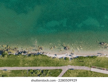 Vertical aerial view of the beach at the road side park of the Mackinac Bridge, north shore, with people swimming, daytime, summer - Shutterstock ID 2280509929