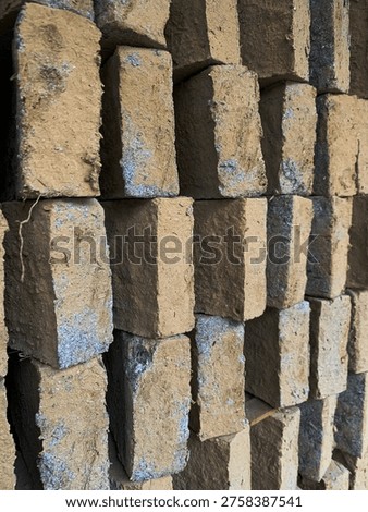 Vertical arrangement of clay bricks creating repetitive industrial texture pattern.