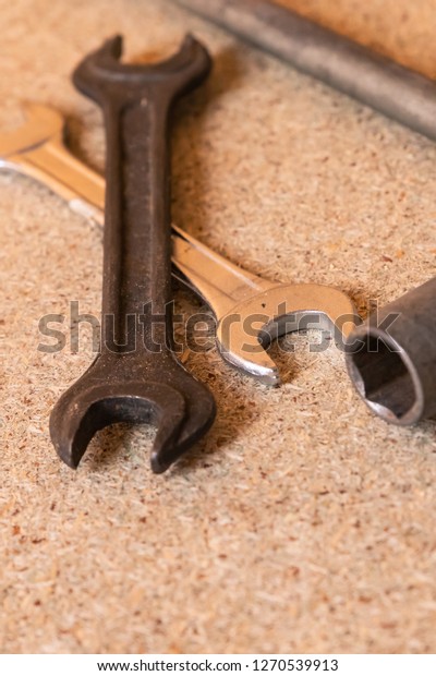 vertical background crossed wrench close up\
wrench metal design\
construction