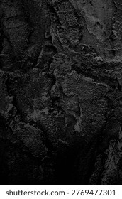 Vertical background of dark solidified stone structure 
