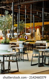 Vertical Background Image Of Empty Food Court Interior In Shopping Mall In Loft Style Decorated By Green Live Plants