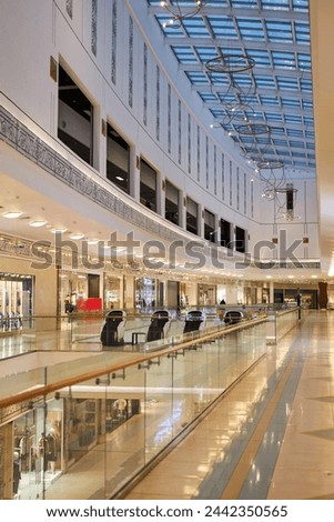 Vertical background image of empty shopping mall interior with glass ceiling copy space