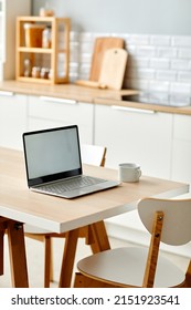 Vertical background image of minimal home workplace with laptop on kitchen table, copy space