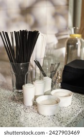 Vertical background image of service setup with salt pepper sugar and straws at self service table in coffee shop