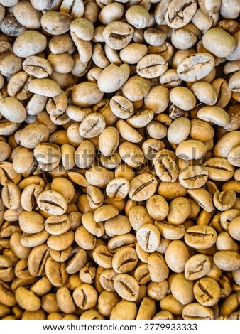 Vertical background texture of raw unroasted green coffee beans full frame pattern