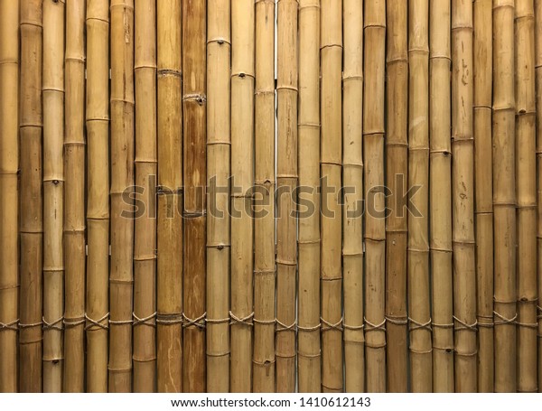 Vertical bamboos interior designed as wall to\
create oriental atmosphere for\
background