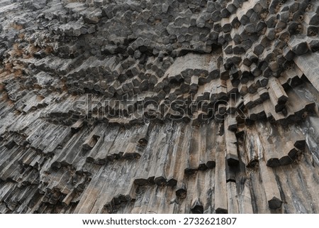 Vertical basalt columns form dense geometric patterns at the Symphony of Stones, dark volcanic rock creates dramatic texture and natural rhythm