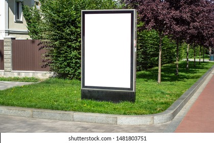 Vertical Billboard Or Citylight Mockup Template Commercial Advertisement Standing On The Grass Near Trees And A House In A Small European Cozy Town Outdoor Street Sunny Summer Day, No People