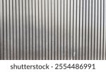 Vertical black and grey wooden wall texture image. Wood slats, wall pattern surface texture. The walls are made of old and damaged wooden boards.