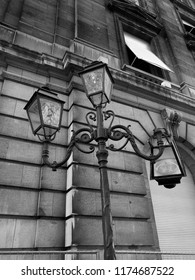 Vertical Black And White Shot Of A Broken Streetlight