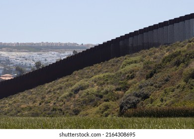 The vertical border fence between the United States and Mexico viewed from the Border Field State Park in San Diego, California. The city of Tijuana, Mexico, is seen over the fence.