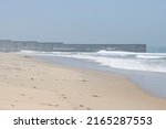 Vertical border fence between the U.S. and Mexico viewed from the beach at the Border Field State Park in San Diego, California. It separates San Diego from Tijuana and extends into the Pacific Ocean.