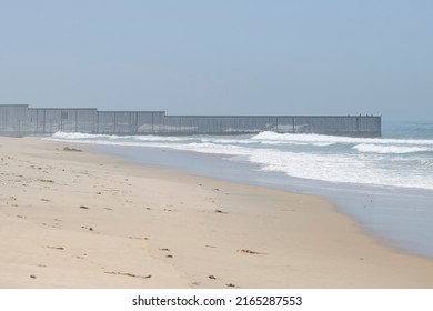 Vertical border fence between the U.S. and Mexico viewed from the beach at the Border Field State Park in San Diego, California. It separates San Diego from Tijuana and extends into the Pacific Ocean.