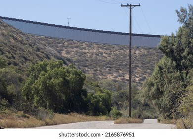A vertical border wall between the United States and Mexico, separating San Diego from Tijuana, viewed from Tijuana River Valley, a rural community in the southern section of San Diego, California.