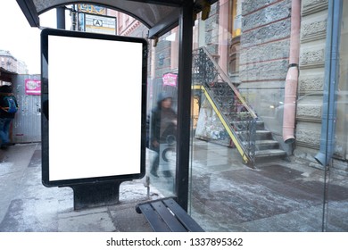 Vertical City Billboard In A Public Transport Stop Bus Shelter. With White Field MOCKUP. In The City Center In The Afternoon With Snow In The Winter Outdoor Advertising Ad.