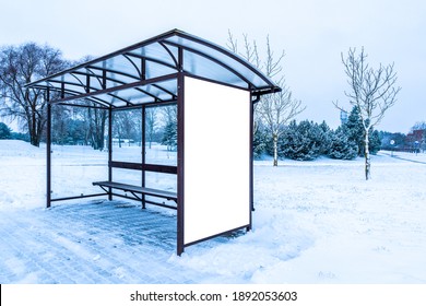 Vertical City Billboard In A Public Transport Stop Bus Shelter. Billboard On Street In Winter.