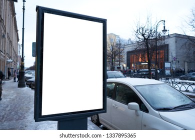 Vertical City Billboard With White Field MOCKUP. In The City Center In The Afternoon With Snow In The Winter Outdoor Advertising Ad.