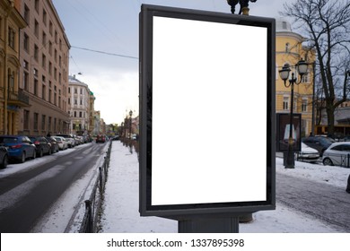 Vertical City Billboard With White Field MOCKUP. In The City Center In The Afternoon With Snow In The Winter Outdoor Advertising Ad