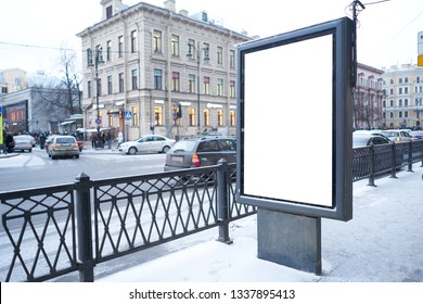 Vertical City Billboard With White Field MOCKUP. In The City Center In The Afternoon With Snow In The Winter Outdoor Advertising Ad.