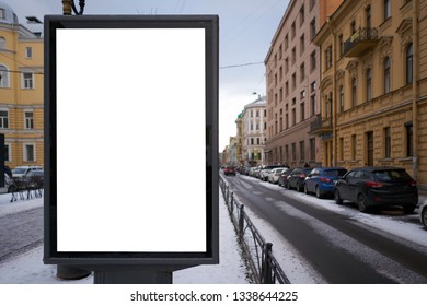 Vertical City Billboard With White Field MOCKUP. In The City Center In The Afternoon With Snow In The Winter Outdoor Advertising Ad