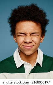 Vertical Close Up Portrait Of Black Teenage Boy Facing Camera With Eyes Closed And Funny Expression