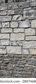 Vertical Close Up View of an Ashlar Limestone Wall with Dark Mortar Joints