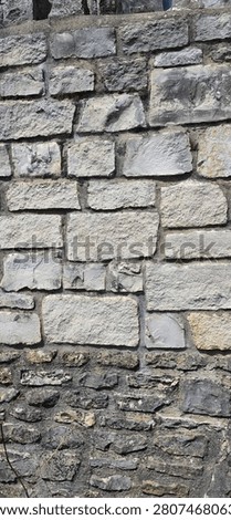 Vertical Close Up View of an Ashlar Limestone Wall with Dark Mortar Joints