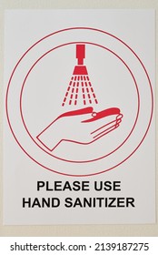 Vertical Close-up No People Conceptual Shot Of Please Use Hand Sanitizer Sign Stuck On Wall