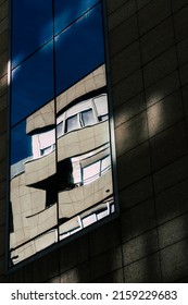 A vertical closeup shot of a building reflected on a window