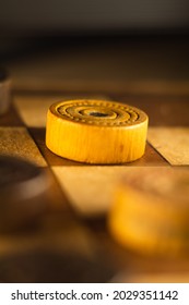 A Vertical Closeup Shot Of A Checkers Board And Wooden Game Pieces On It