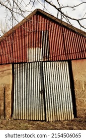 Vertical Closeup Shot Of An Old Warehouse With Zinc Door And Attic Wall