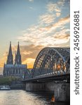 vertical of the Cologne Cathedral and Hohenzollern Bridge at sunset