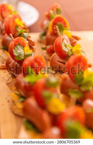 Vertical composition of elegant appetizer skewers with colorful vegetables and cheese for catering presentation.