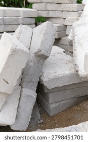 Vertical composition featuring stacked concrete blocks arranged at a construction site. Perfect for construction, architecture, engineering and industrial backgrounds with copy space.