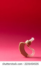 Vertical composition of hearing aid on red background with copy space. Medical services, healthcare and health awareness concept. - Shutterstock ID 2231454535