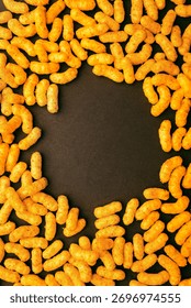 Vertical composition of peanut puff snacks forming circle with copy space, perfect for design background, banner, or packaging mockup