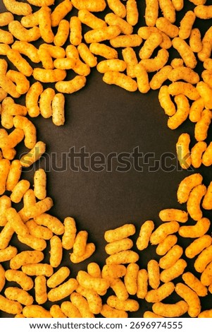 Vertical composition of peanut puff snacks forming circle with copy space, perfect for design background, banner, or packaging mockup