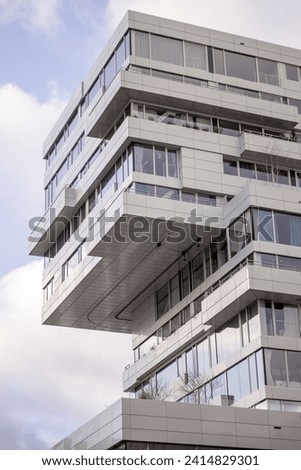 Vertical construction architecture of contemporary modern high rise office building in financial district in Utrecht with reflecting exterior facades